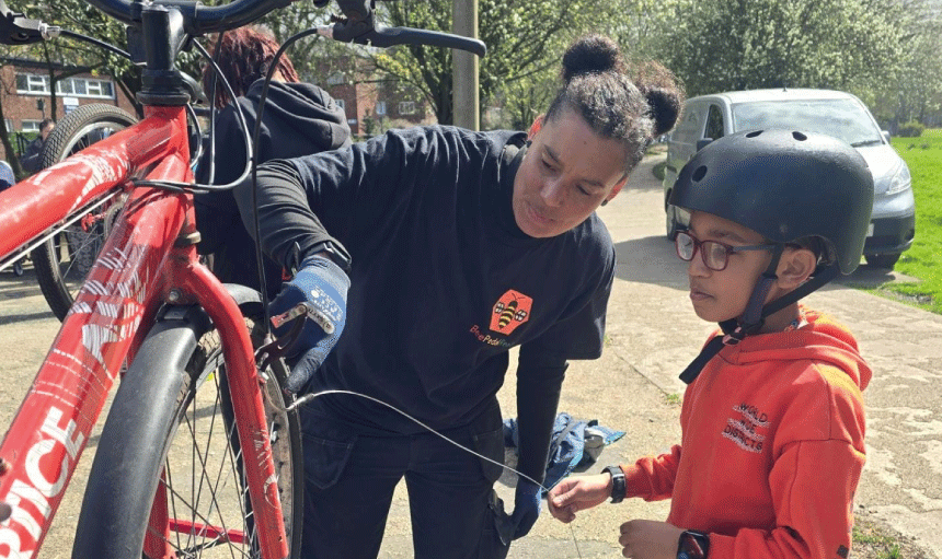 Belinda Everett performing bike maintenance