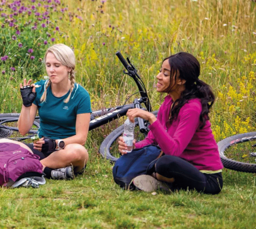 Women Sat on Grass with bikes