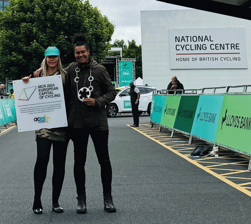 GM Bicycle Mayor Belinda Everett holding European Capital of Cycling Plaque at Start line of Tour of Britain Women 2024, National Cycling Centre